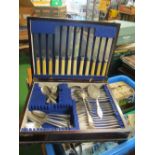 A mixture of plated cutlery in an Edwardian cutlery box