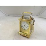 A lacquered brass carriage clock, retailed Taylor & Blight