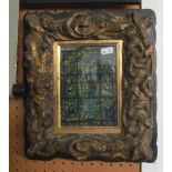 A small carved gilt frame with print of a stained glass window