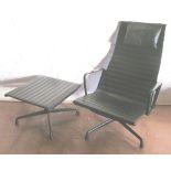 An Eames black leather chair Alu EA124 and stool EA125 (foot damaged) with VITRA label