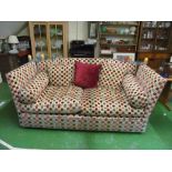 A modern Knoll style settee upholstered in a circle pattern fabric on beige ground