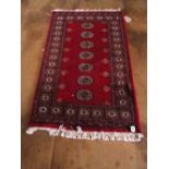 A Bokhara red ground rug