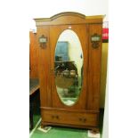 An Edwardian satin walnut mirror door wardrobe with jasperware style panels of dancing figures and