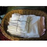 Various linen tablecloths, napkins et cetera including a Ritz tablecloth in a wicker basket