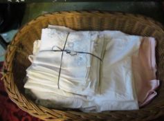 Various linen tablecloths, napkins et cetera including a Ritz tablecloth in a wicker basket