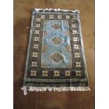 A pale blue Pakistani Ghom rug geometric design