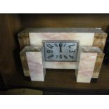 An Art Deco marble effect clock, square dial with two turrets side pieces