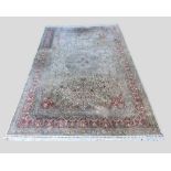 A North West Persian Silk Large Carpet with a central medallion with an all over design upon a