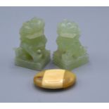 A Pair Of Chinese Jade Carved Models in the form of fou dogs 6 cms tall together with a horn and