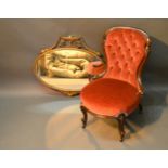 A Victorian Mahogany Low Seat Nursing Chair together with an oval gilded wall mirror