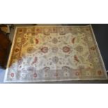 A North West Persian Style Woollen Carpet with an all over design upon a cream and red ground within