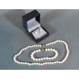 A Cultured Pearl Necklace with 18ct yellow gold clasp together with a matching bracelet and a pair