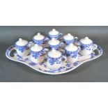 A Set of Nine Minton Porcelain Covered Chocolate Pots on shaped stand all decorated in underglaze