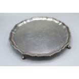 A London Silver Presentation Salver retailed by Garrard & Co. of shaped outline with four hoof feet,