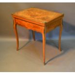 A French Marquetry Inlaid and Gilt Metal Mounted Card Table, the hinged top enclosing a baise
