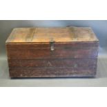 An Early 20th Century Chest, the hinged plank top above a similar front with iron handles, 120 cms