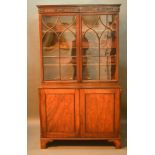 A 19th Century Mahogany Bookcase, the moulded cornice above two astragal glazed doors enclosing