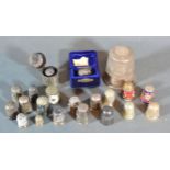 A Sterling Silver Commemorative Thimble together with a collection of other thimbles, some silver