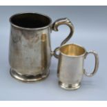 A Birmingham Silver Mug of tapered form with circular base and shaped handle by Elkington & Co.