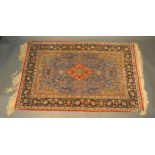 A North West Persian Silk Rug with a central medallion within an all over design upon a blue, red