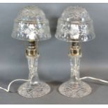 A Pair Of Cut Glass And Silver Plated Table Lamps with cut glass shades, 36 cms tall