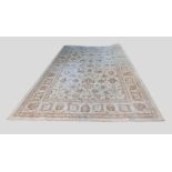A North West Persian Style Large Woollen Carpet with an all over design upon a cream ground within