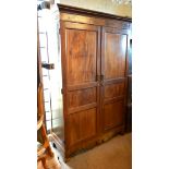 A 19th Century Mahogany Hall Cupboard, the moulded cornice above two panelled doors with line inlays