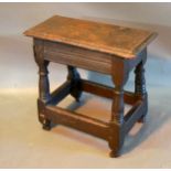 An Early Oak Joint Stool, the moulded top above turned legs with stretchers 56 x 26 cm 53 high