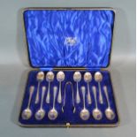 A Set of Twelve Sheffield Teaspoons with rat tail decoration together with matching sugar tongs