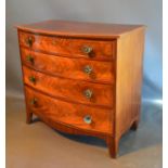 A Regency Mahogany Bow Fronted Chest, the cross banded and inlaid top above four drawers with