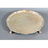 A London Silver Salver of shaped outline with four ball and claw feet, 18 ozs. 25 cms diameter