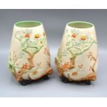 A Pair Of Clarice Cliff Vases decorated in relief with flowering vine, 20 cms tall