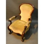 A Victorian Mahogany Drawing Room Armchair, the shaped and padded back above a similar serpentine