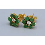 A Pair Of Yellow Metal Diamond And Emerald Ear Studs of cluster form, 9mm diameter