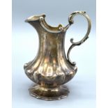 A Victorian Silver Cream Jug of shaped ribbed form and with shaped foot, London 1844, maker's mark