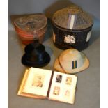 A Top Hat in original leather case together with a pith helmet within metal case and a Victorian