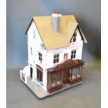 A Scratch Built Dolls' House modelled as Busbridge Stores with shop front complete with a large