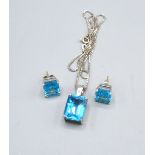 An 18ct Gold Pendant Set Rectangular Blue Topaz with 18ct gold linked chain 16 x 11 mm, together
