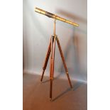 A Brass And Leather Telescope with adjustable wooden and brass mounted tripod 145 cms tall