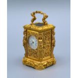 A Cast Brass French Style Miniature Carriage Clock, the enamel dial with Roman and Arabic numerals