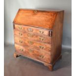 A 19th Century Mahogany Bureau, the fall front enclosing a fitted interior above four long drawers