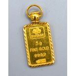 A 24ct. Gold Pendant within gold mount, pendant 5 gms. and the mount 22ct. 2.7 gms.