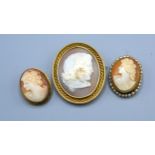 An Oval Cameo Brooch decorated in relief with a classical bust together with two other cameo