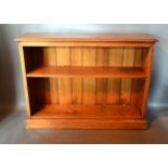 A Green Oak Bookcase, the moulded top above two shelves with boarded back raised upon a plinth base,