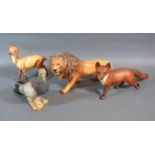 A Beswick Model Of A Lion together with three other Beswick models to include a fox, a pigeon and