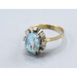 A White Metal Dress Ring Set Oval Aquamarine surrounded by diamonds, 5.1 gms, ring size R