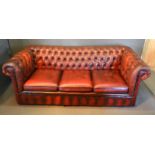 A Burgundy Red Leather And Button Upholstered Chesterfield Sofa, 192 cms wide x 83 cms deep x 70 cms