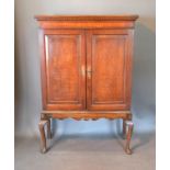 A George III Oak Side Cabinet, the moulded inlaid cornice above two panelled doors enclosing shelves