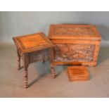 A Carved Oak Blanket Box with four carved panels depicting mythical creatures together with a