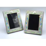 A Pair Of Sterling Silver And Enamel Decorated Rectangular Photograph Frames of embossed stylised